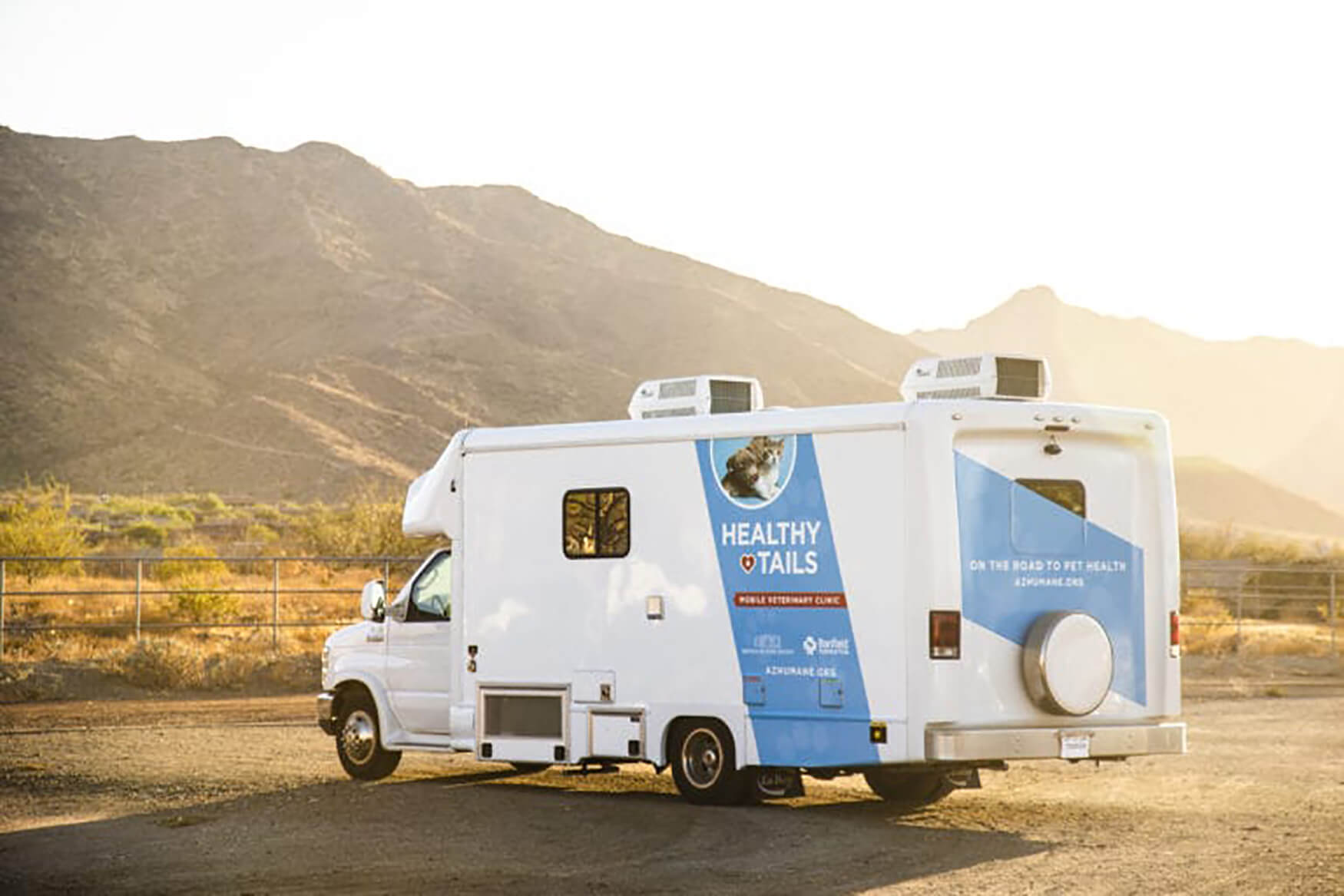 The Healthy Tails Mobile Unit parked in front of hills