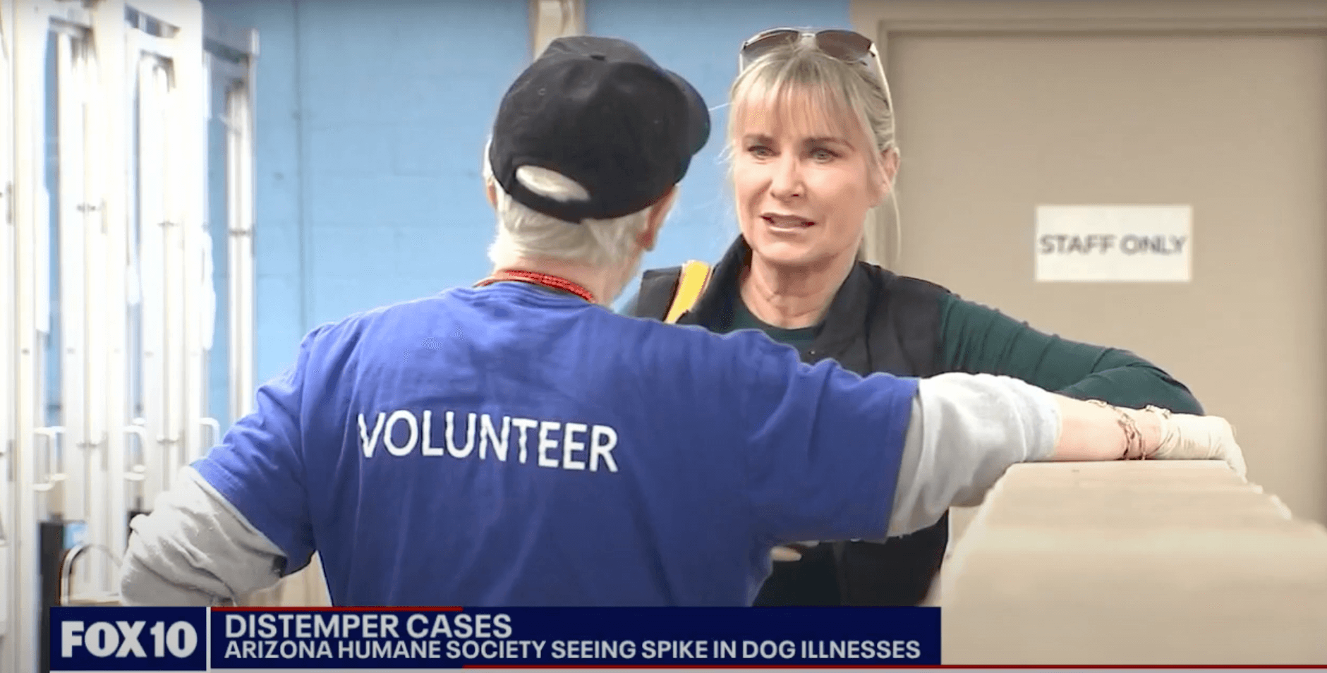 speaking with a volunteer on the news