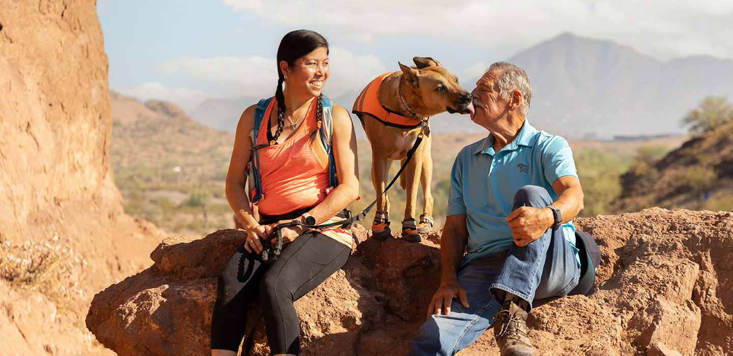 Woman with dog and older man on hike